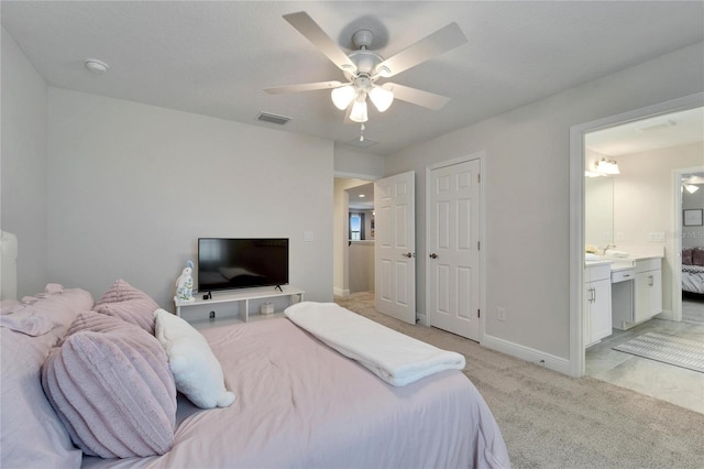 bedroom featuring baseboards, visible vents, connected bathroom, light colored carpet, and ceiling fan