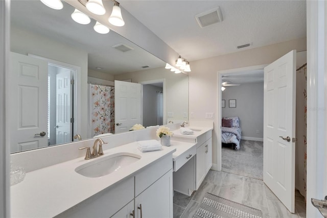 bathroom with visible vents, a sink, ensuite bath, and double vanity