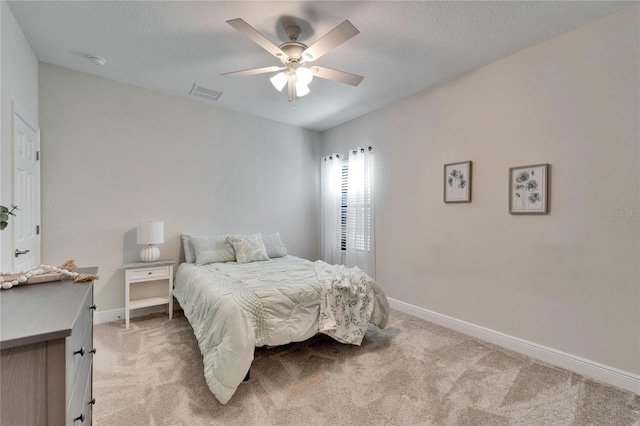 bedroom featuring light colored carpet, visible vents, ceiling fan, and baseboards