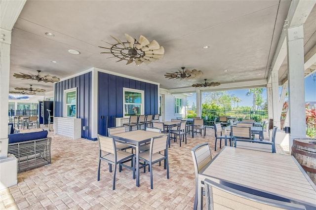 view of patio / terrace featuring ceiling fan, outdoor dining space, and fence