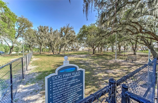 view of property's community featuring fence and a lawn