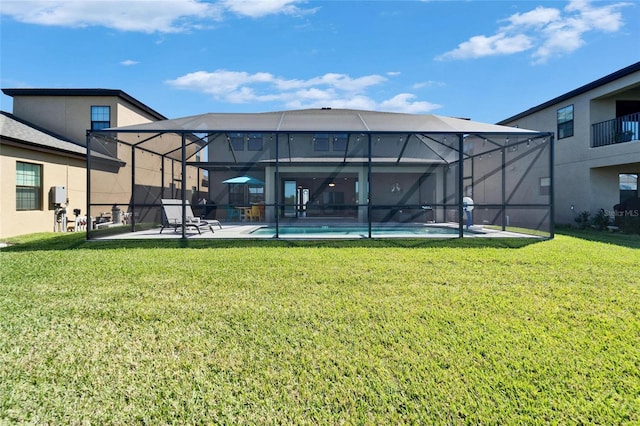 back of house featuring a patio area, an outdoor pool, glass enclosure, and a yard