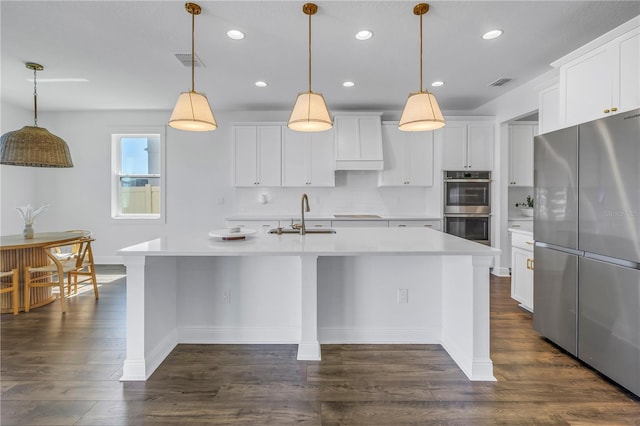 kitchen featuring visible vents, stainless steel appliances, a sink, and light countertops