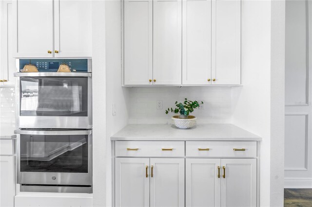 interior space with tasteful backsplash and stainless steel double oven