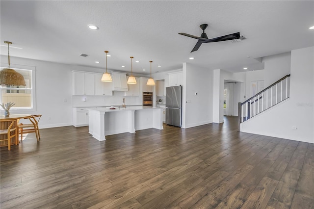 living area featuring stairs, dark wood finished floors, a ceiling fan, and recessed lighting