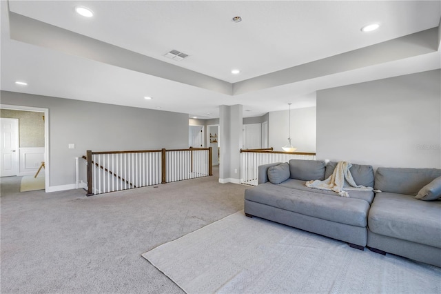 living room featuring carpet, visible vents, baseboards, and recessed lighting