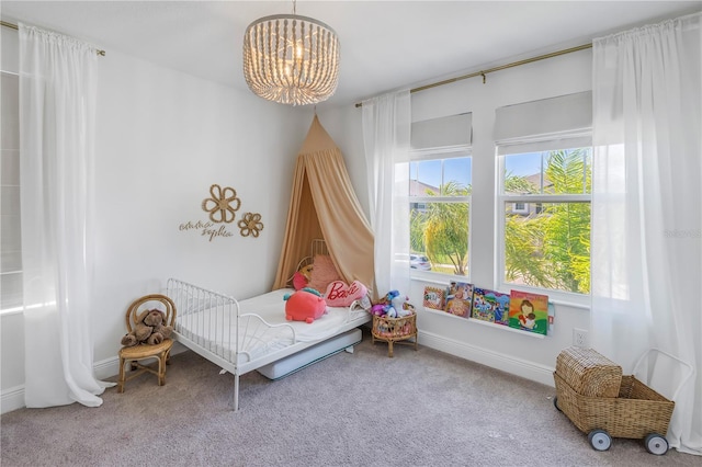 bedroom with carpet floors, baseboards, and an inviting chandelier