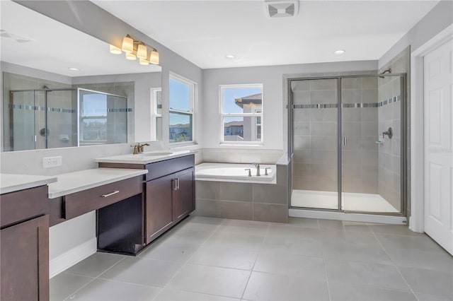 full bathroom featuring tile patterned flooring, vanity, visible vents, a bath, and a stall shower