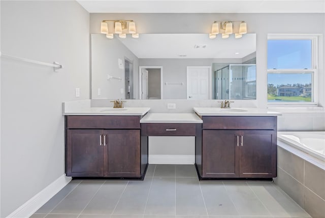 full bathroom with a stall shower, two vanities, a sink, and tile patterned floors