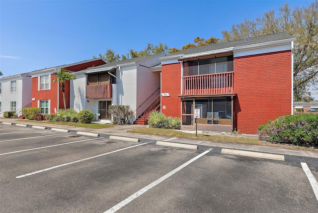 view of property featuring uncovered parking