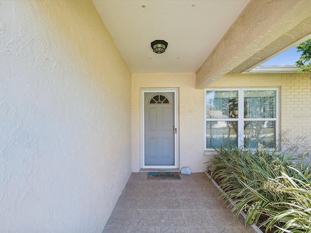 doorway to property with stucco siding