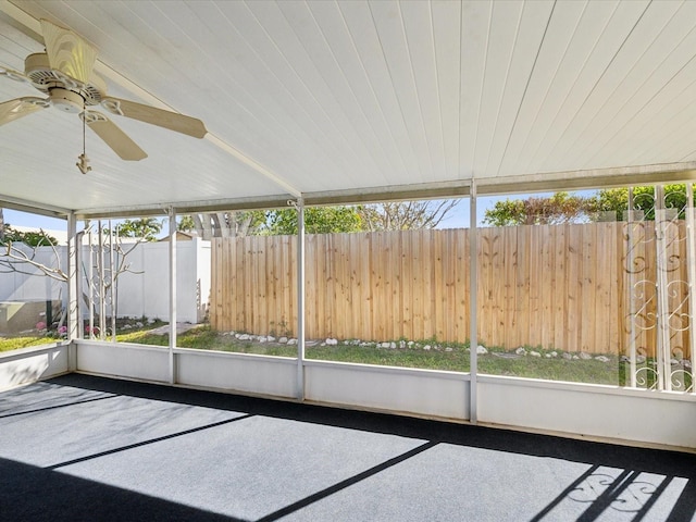 unfurnished sunroom featuring ceiling fan and wooden ceiling