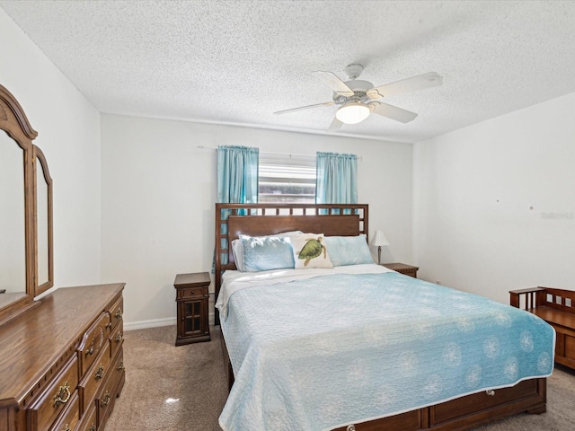 bedroom with baseboards, carpet, a ceiling fan, and a textured ceiling