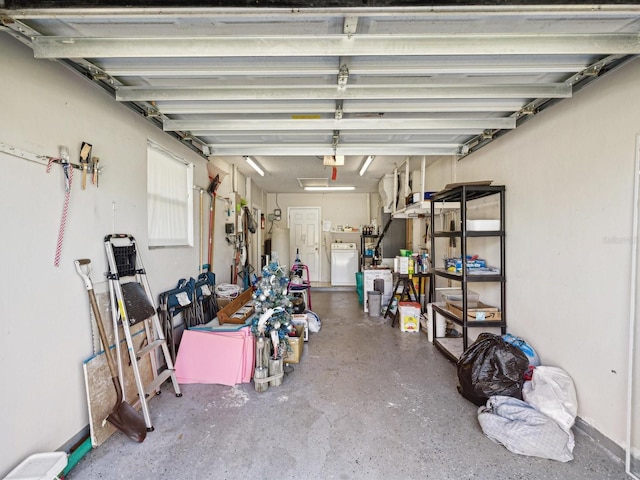 garage featuring water heater and separate washer and dryer