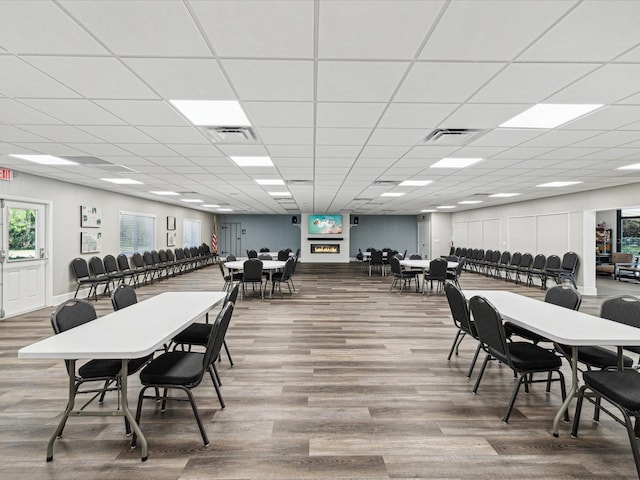 dining room featuring a drop ceiling, visible vents, and wood finished floors