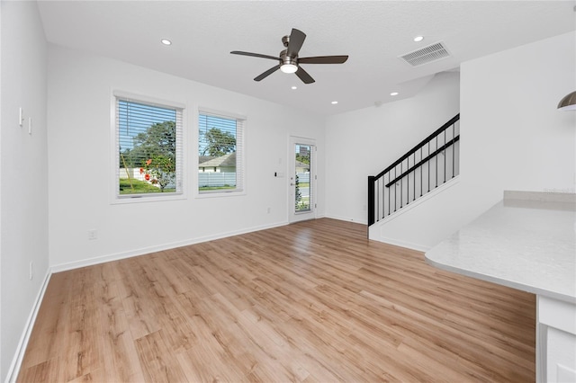3402 E 28th Ave Unit 7, Tampa, FL 33605 - unfurnished living room with stairs, light wood-style floors, ceiling fan, recessed lighting, and baseboards