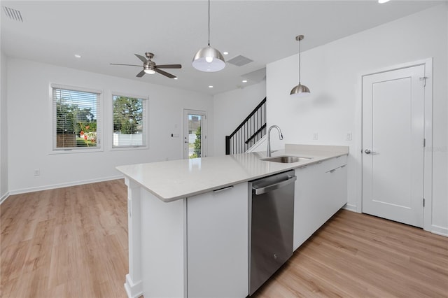 3402 E 28th Ave Unit 7, Tampa, FL 33605 - kitchen with stainless steel dishwasher, a sink, light wood-style floors, a peninsula, and light countertops
