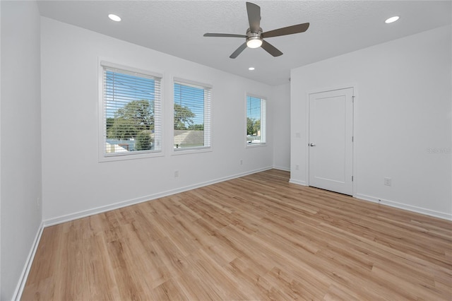 3402 E 28th Ave Unit 7, Tampa, FL 33605 - unfurnished room featuring light wood-type flooring, ceiling fan, baseboards, recessed lighting, and a textured ceiling
