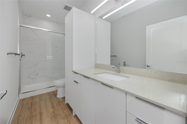 3402 E 28th Ave Unit 7, Tampa, FL 33605 - bathroom featuring vanity, a marble finish shower, toilet, wood finished floors, and recessed lighting