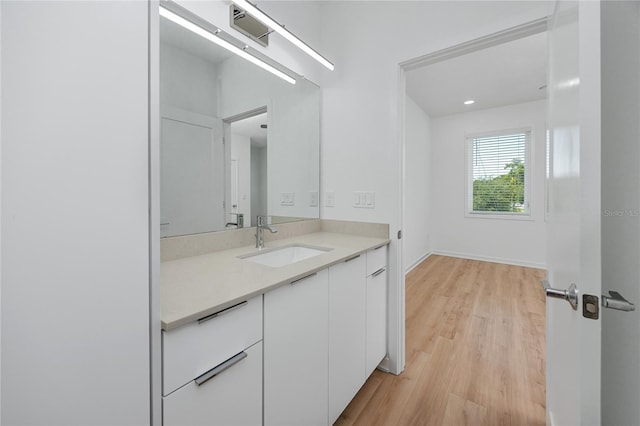 3402 E 28th Ave Unit 7, Tampa, FL 33605 - bathroom with wood finished floors, vanity, and baseboards
