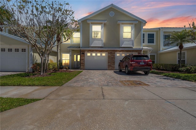 view of front of home with decorative driveway and an attached garage