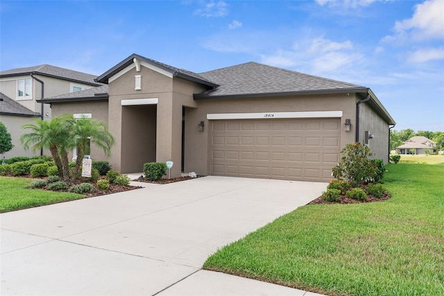 view of front of home featuring stucco siding, a garage, a front yard, driveway, and roof with shingles