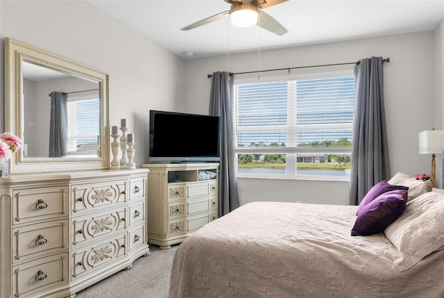 bedroom with light carpet and ceiling fan