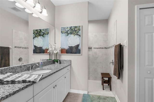 full bathroom with a walk in shower, vanity, and tile patterned floors