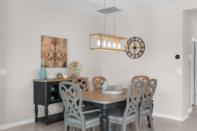 dining area featuring baseboards and tile patterned floors