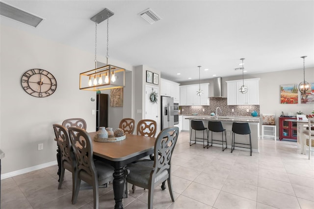 dining space featuring recessed lighting, light tile patterned floors, and baseboards