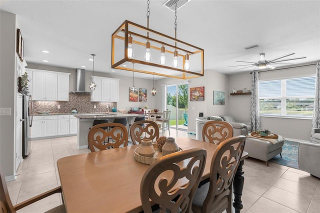 dining room featuring light tile patterned flooring, a ceiling fan, recessed lighting, and baseboards