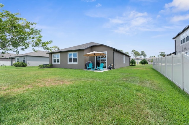back of property featuring a patio and stucco siding