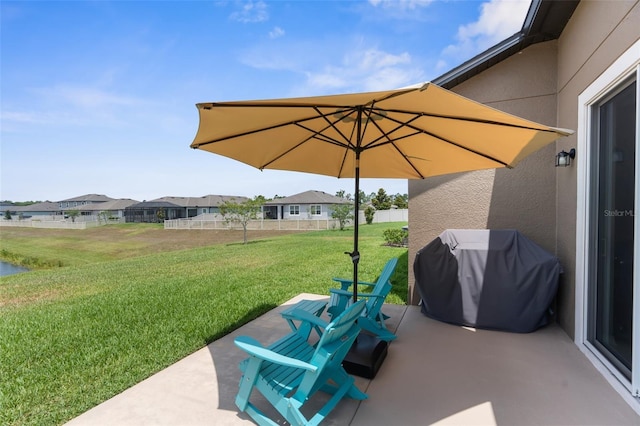view of patio featuring a grill and a residential view