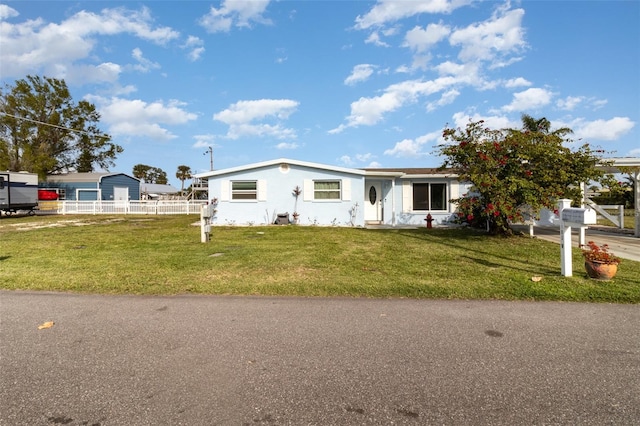 view of front facade featuring a front yard and fence