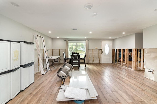 interior space featuring visible vents, recessed lighting, light wood-style floors, and a wainscoted wall