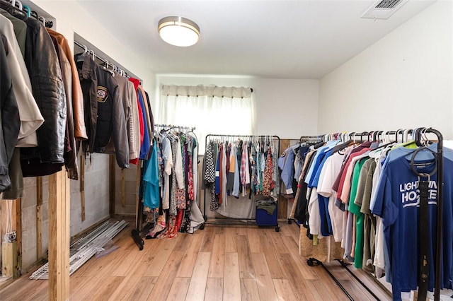 walk in closet with visible vents and wood finished floors