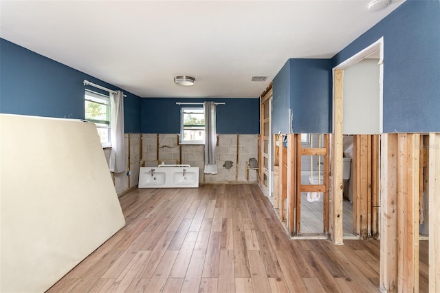 bathroom featuring visible vents, a wainscoted wall, and wood finished floors