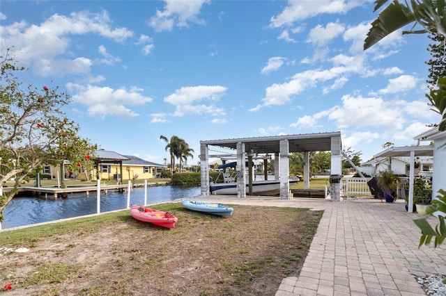 view of play area with a water view, boat lift, and a dock