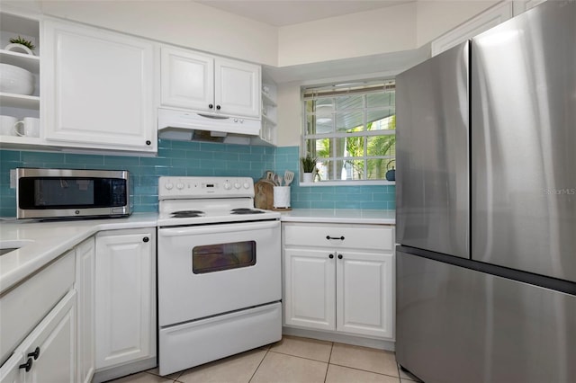 kitchen with under cabinet range hood, white cabinetry, light countertops, appliances with stainless steel finishes, and backsplash