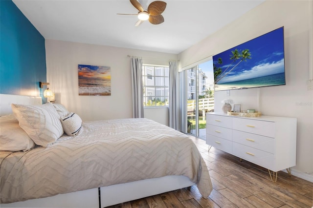 bedroom with access to exterior, a ceiling fan, and wood finished floors