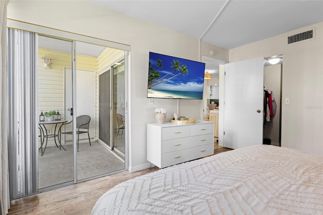 bedroom with visible vents and wood finished floors