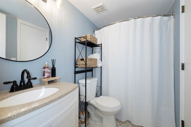 bathroom featuring toilet, visible vents, a shower with shower curtain, and vanity