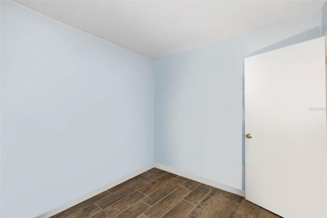 spare room with wood finish floors and baseboards