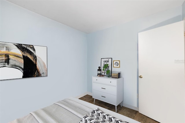 bedroom featuring baseboards and wood finished floors