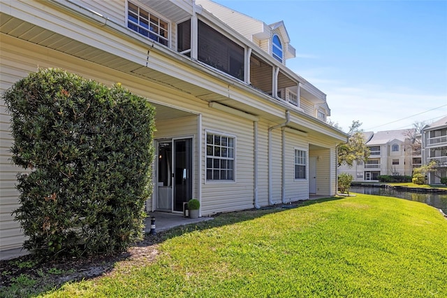 exterior space with a lawn and a water view