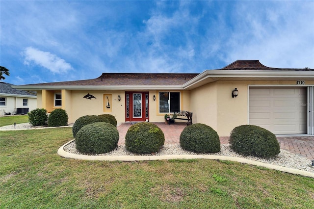 ranch-style house with driveway, an attached garage, central AC, stucco siding, and a front lawn