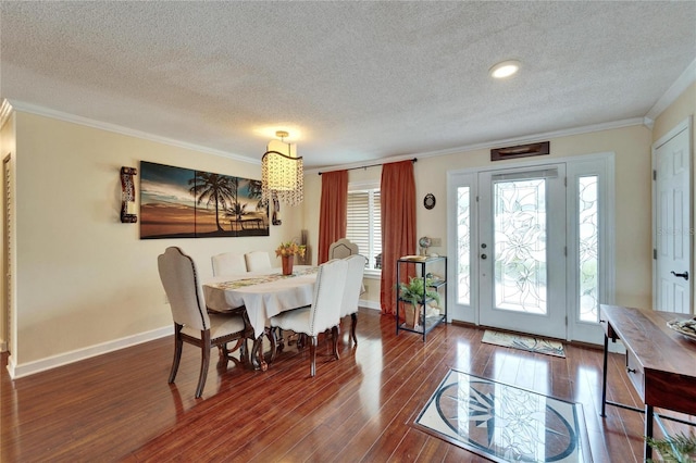 dining room with dark wood-type flooring, crown molding, and baseboards