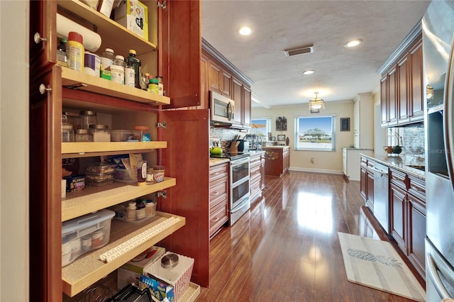 kitchen with visible vents, dark wood-type flooring, tasteful backsplash, and appliances with stainless steel finishes