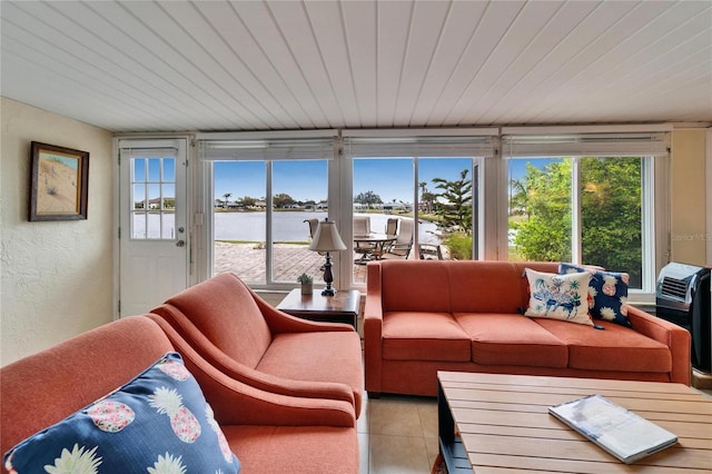 sunroom / solarium with wood ceiling and a water view