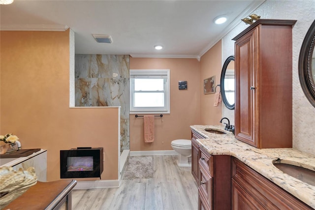 bathroom featuring walk in shower, toilet, a fireplace, and ornamental molding